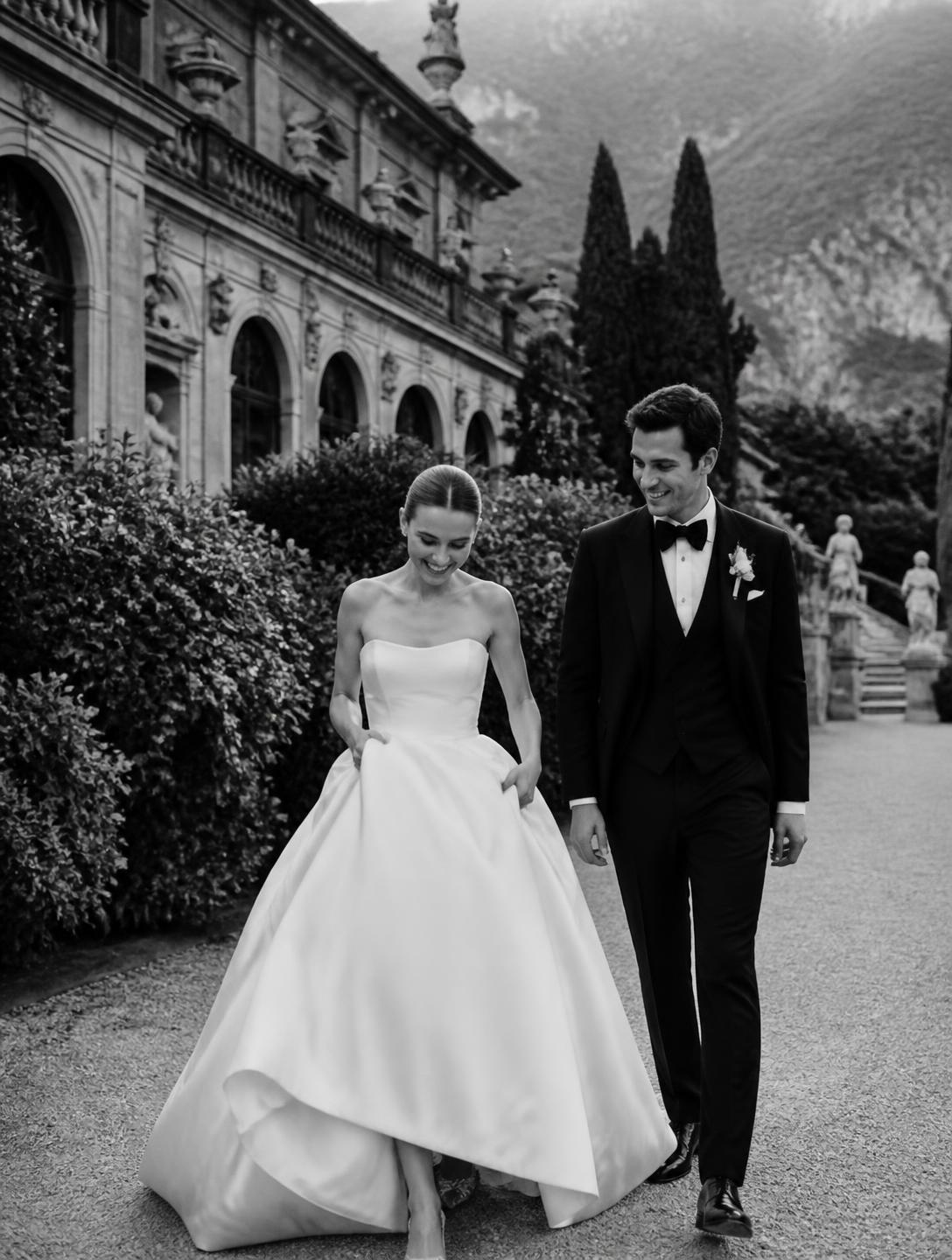 Newlywed couple walking through the villa gardens